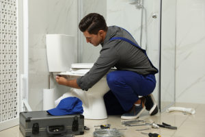 plumber fixing toilet